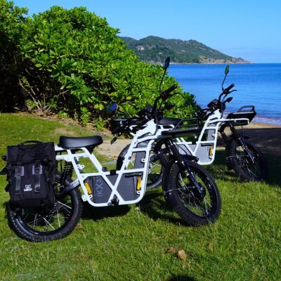 a motorcycle parked on the side of a lake