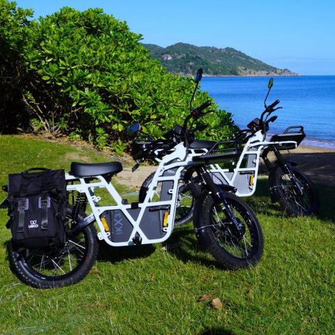 a motorcycle parked on the side of a lake