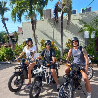 a group of people riding on the back of a motorcycle