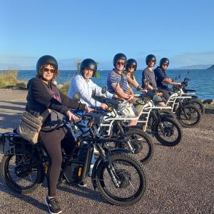 a group of people standing around a motorcycle