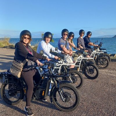 a group of people standing around a motorcycle