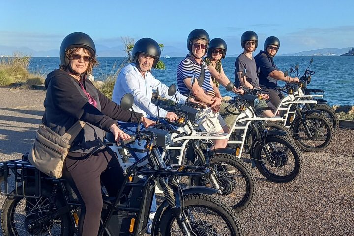 a group of people standing around a motorcycle