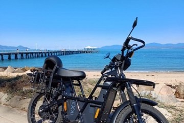 a motorcycle parked on the side of a beach