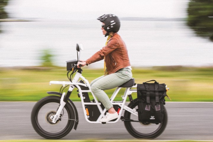 a woman riding on the back of a motorcycle