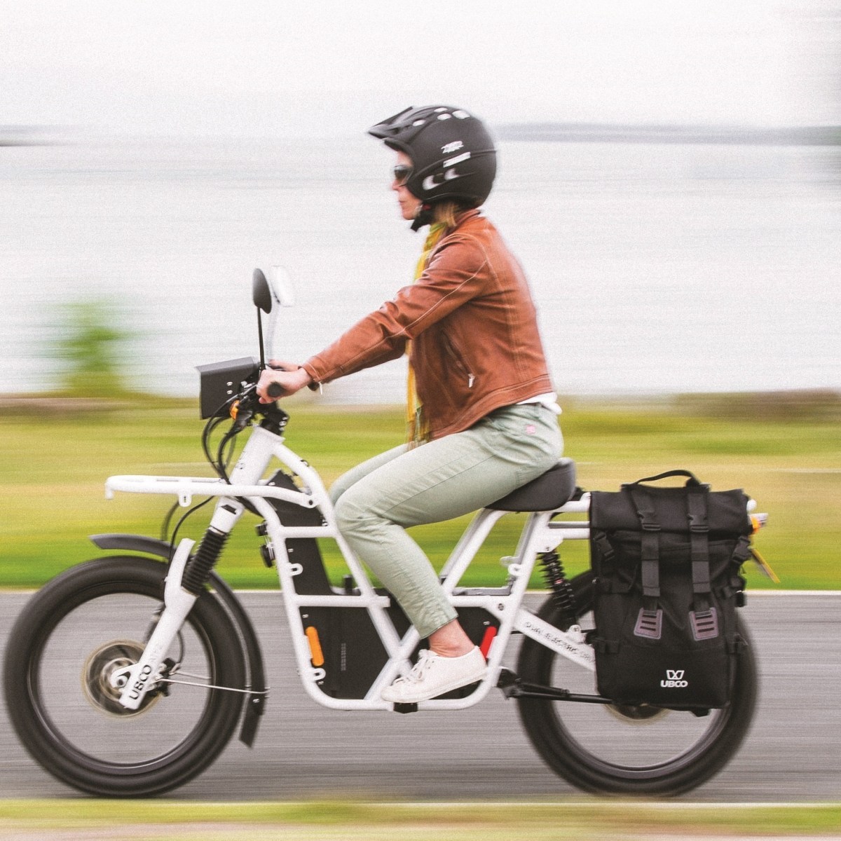 a woman riding on the back of a motorcycle