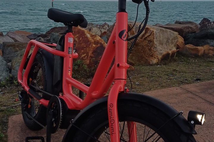 a motorcycle parked next to a body of water