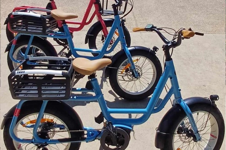 a bicycle is parked next to a blue motorcycle