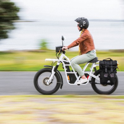 a woman riding on the back of a motorcycle
