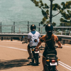 a person riding a motorcycle on the side of a road
