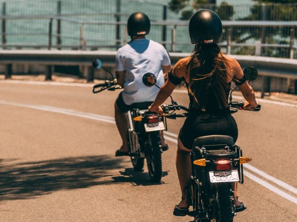 a person riding a motorcycle on the side of a road